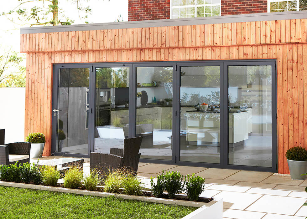 https://www.stedek.co.uk/wp-content/uploads/2018/04/Extension-black-aluminium-bifold-door.jpg