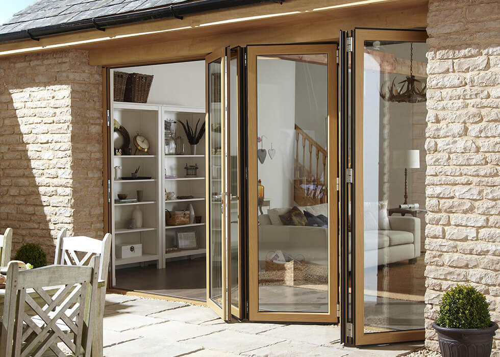 https://www.stedek.co.uk/wp-content/uploads/2018/04/Oak-effect-aluminium-bifold-door.jpg